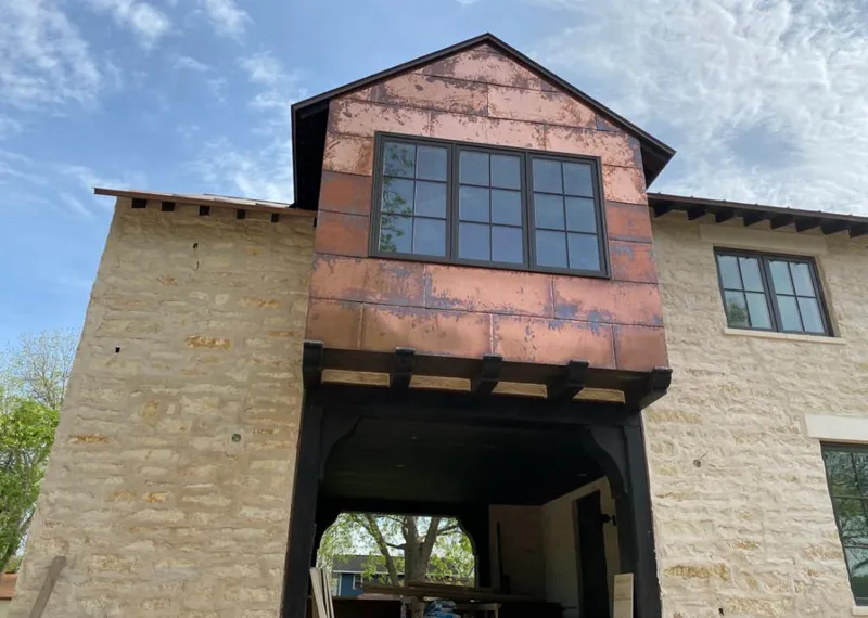 Copper metal panel facade on a stone building for Roof Repair in Mira Monte